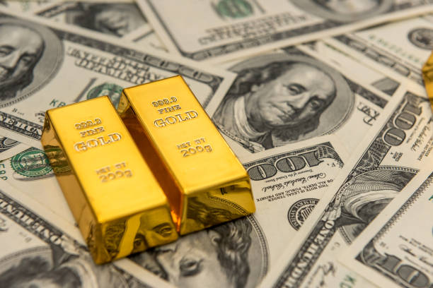Gold bullion and 100 US money banknotes