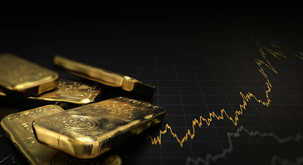 gold ingots over black background with market chart