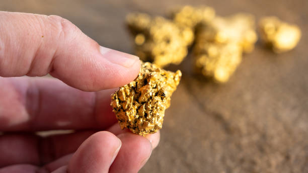 gold nugget held by hand